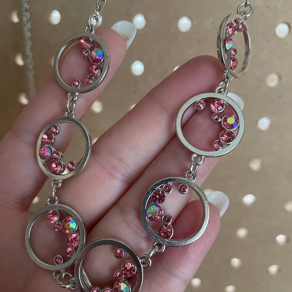 Shorter silver circles necklace with tiny peachy pink stones.